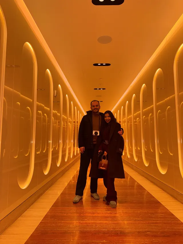 Nate and Angie together in a glowing mirrored hallway