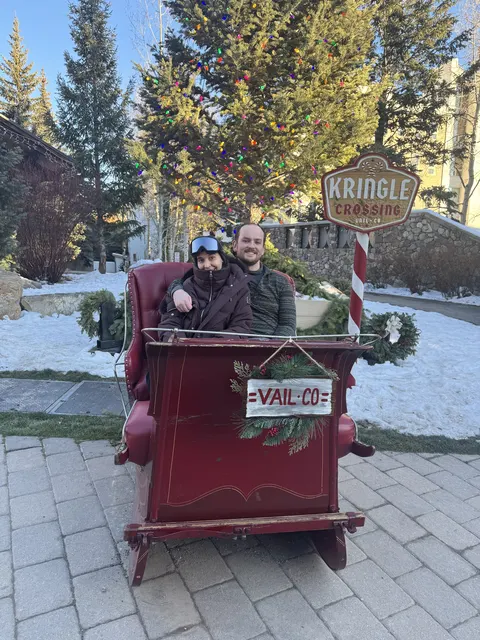 Nate and Angie sitting together in a holiday sleigh in Vail