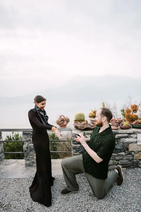 Nate proposing to Angie beside a mountain lake
